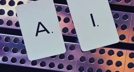 Close-up of letters of A I on cards against railing.