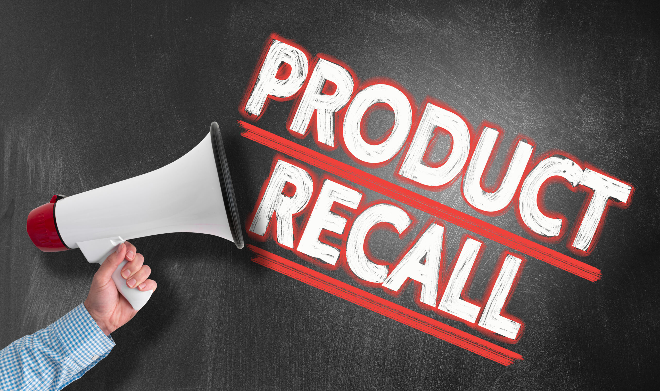 Hand holding megaphone or bullhorn against blackboard with text PRODUCT RECALL.