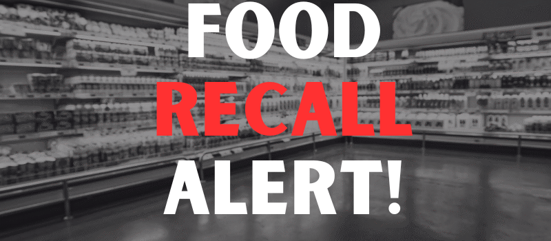 Defocused blur buying milk put on shelf in supermarket with food recall texts.