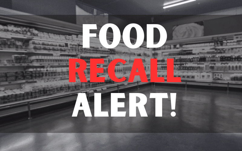 Defocused blur buying milk put on shelf in supermarket with food recall texts.