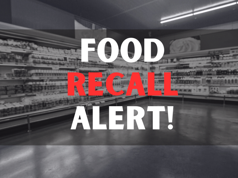 Defocused blur buying milk put on shelf in supermarket with food recall texts.
