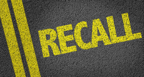 Yellow painted recall on the concrete.