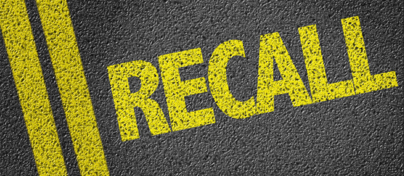 Yellow painted recall on the concrete.