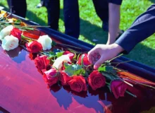 Shot of roses and flowers on top of coffin.