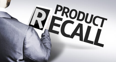 Product recall with a man in suit holding the letter "R" on a tablet device.