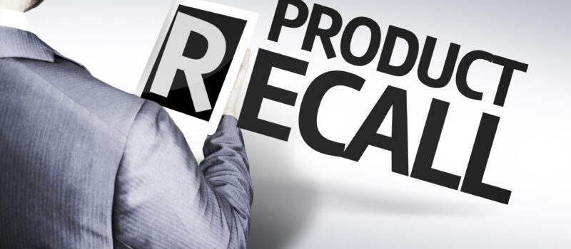 Product recall with a man in suit holding the letter "R" on a tablet device.