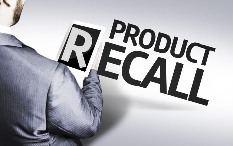 Product recall with a man in suit holding the letter "R" on a tablet device.