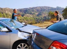 Two men arguing about damaged cars. rear-ended while stopped