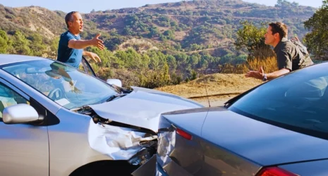 Two men arguing about damaged cars. rear-ended while stopped