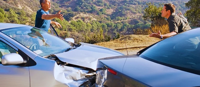 Two men arguing about damaged cars. rear-ended while stopped