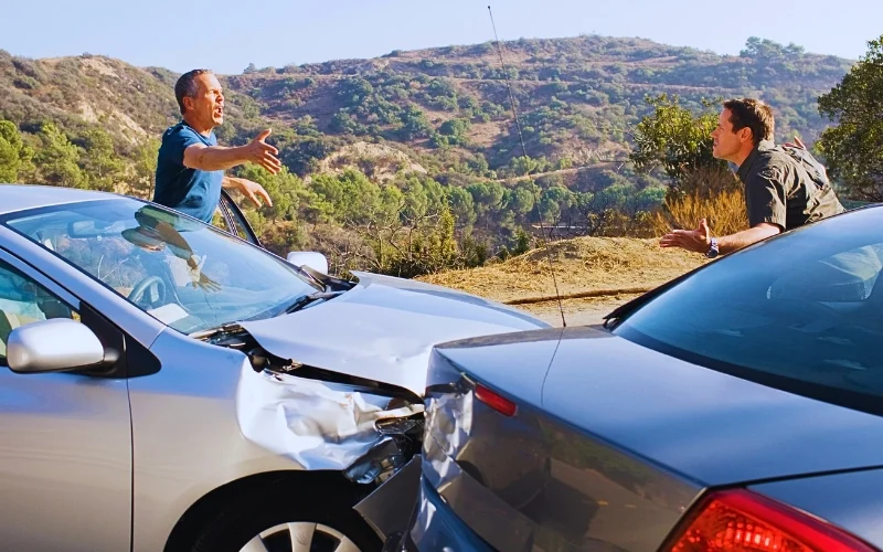 Two men arguing about damaged cars. rear-ended while stopped