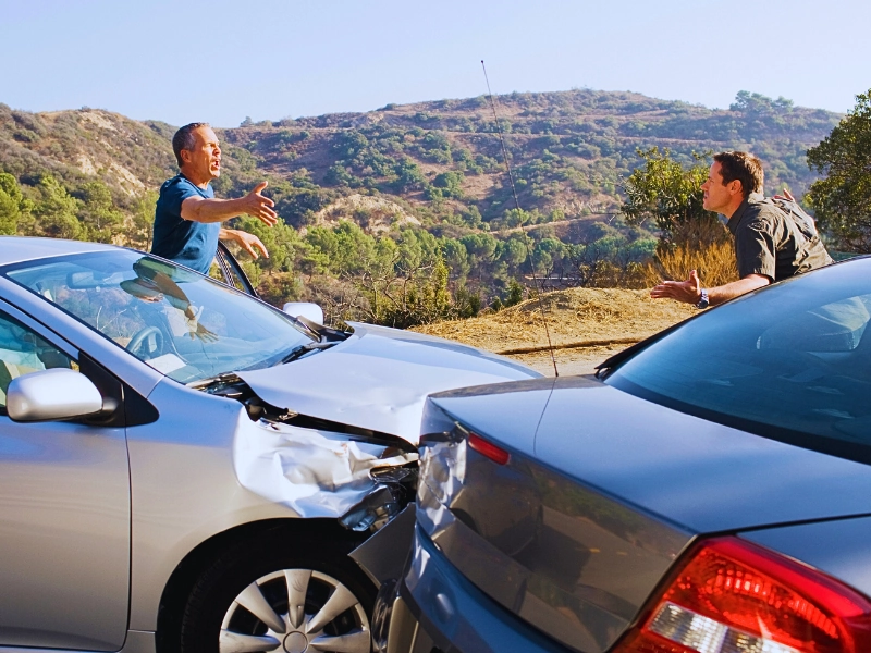 Two men arguing about damaged cars. rear-ended while stopped