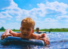 Boy with a rubber ring floats in the summer.