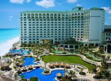 A large, modern resort with a white multi-story building facing a bright blue ocean. Injuries at Florida Hotels and Resorts