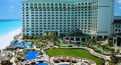 A large, modern resort with a white multi-story building facing a bright blue ocean. Injuries at Florida Hotels and Resorts