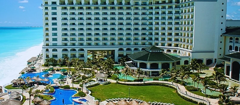A large, modern resort with a white multi-story building facing a bright blue ocean. Injuries at Florida Hotels and Resorts