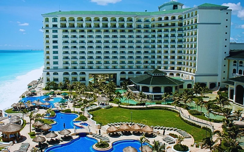 A large, modern resort with a white multi-story building facing a bright blue ocean. Injuries at Florida Hotels and Resorts