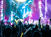 A crowd of people in front of the stage filled with purple and blue lights for a big concert Injuries at Tampa Sporting Events