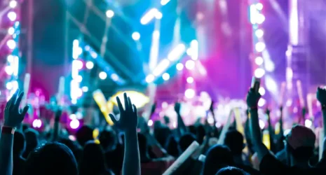 A crowd of people in front of the stage filled with purple and blue lights for a big concert Injuries at Tampa Sporting Events