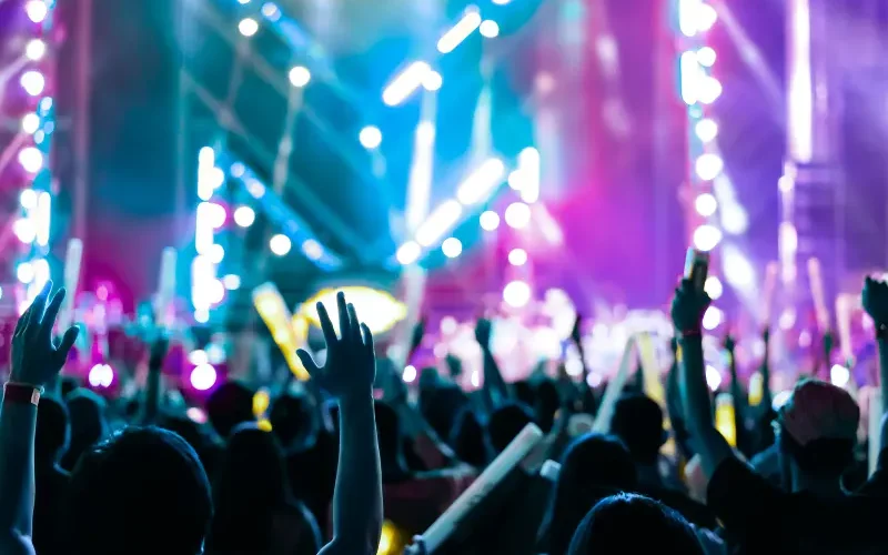 A crowd of people in front of the stage filled with purple and blue lights for a big concert Injuries at Tampa Sporting Events