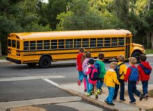 A group of kids waiting to get into their school bus.